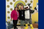 The SCEA President Sherry East poses with winner Mrs. Holub-Ward and Ollie the Owl.