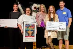 The art contest winner poses with The SCEA President Sherry East, The SCEA mascot Ollie the Owl, her art teacher, and her family. Pictured left to right: Art teacher Kelly Lucarelli, The SCEA President Sherry East, Anna Dellinger's mother, student artist Anna Dellinger, Anna Dellinger's father. Lucarelli and Dillinger are both holding large checks, and Sherry East is holding a print of Dellinger's award winning art.