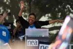 NEA President Becky Pringle raises her arms and cheers with the crowd at the July 5 2023 Freedom to Learn rally in Orlando