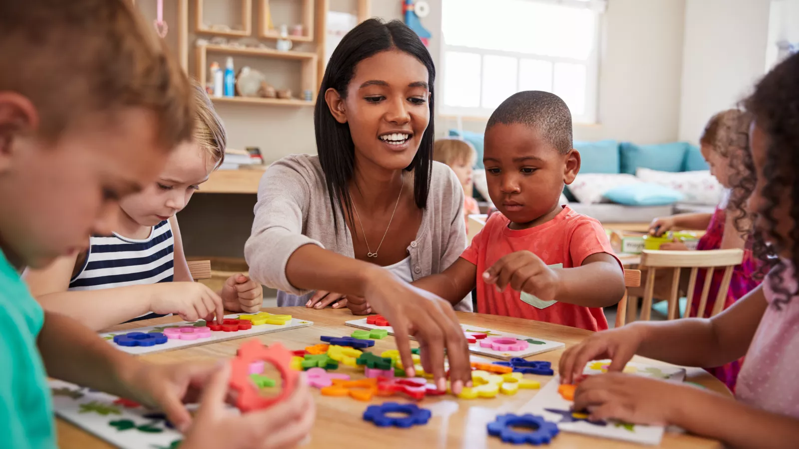 Pre-Kindergarten teacher working with a small group of students