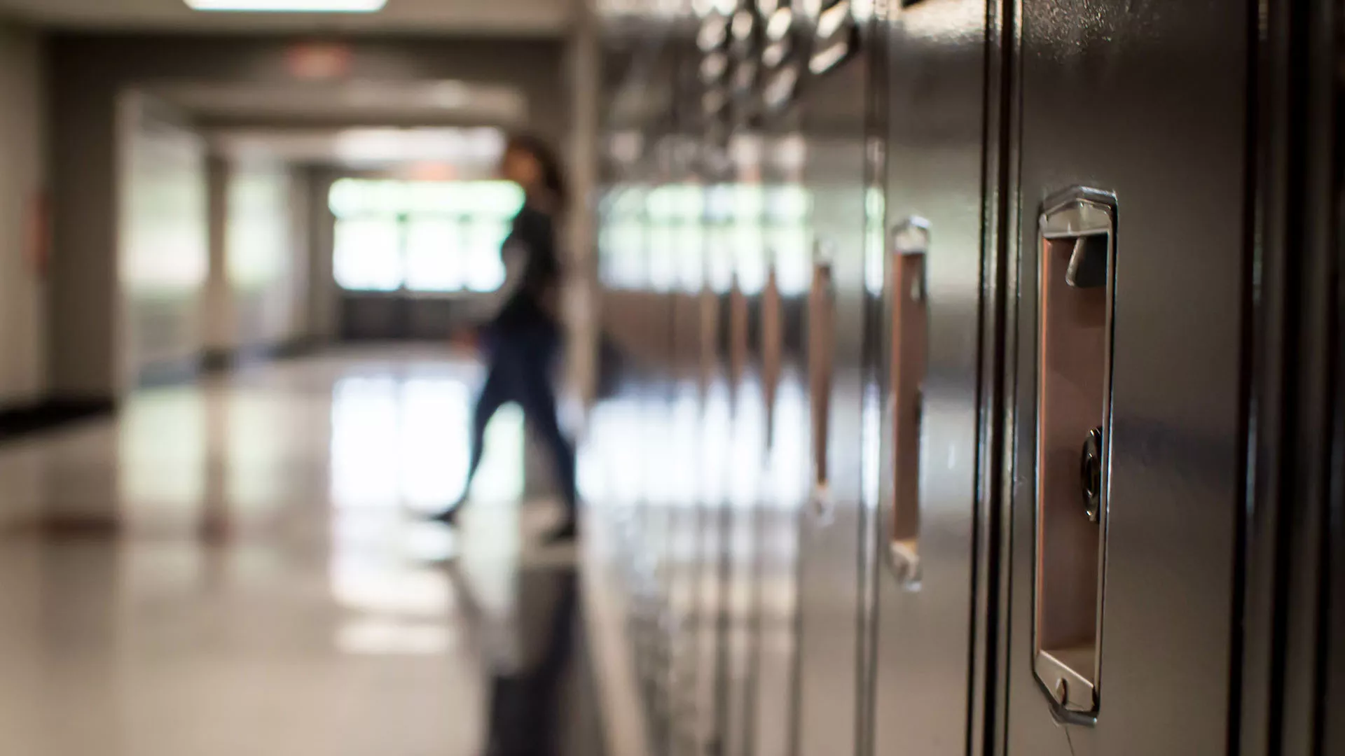 blurred photo of teacher walking in school hallway