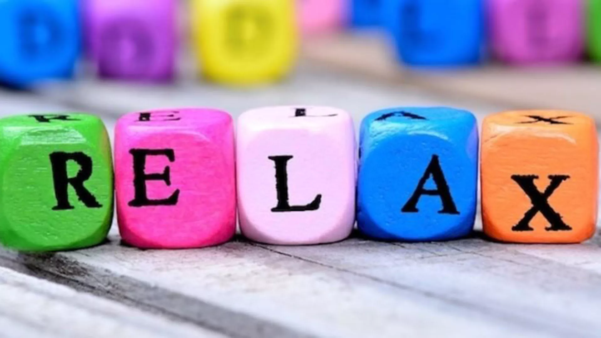 brightly colored cubes that spell out the word relax