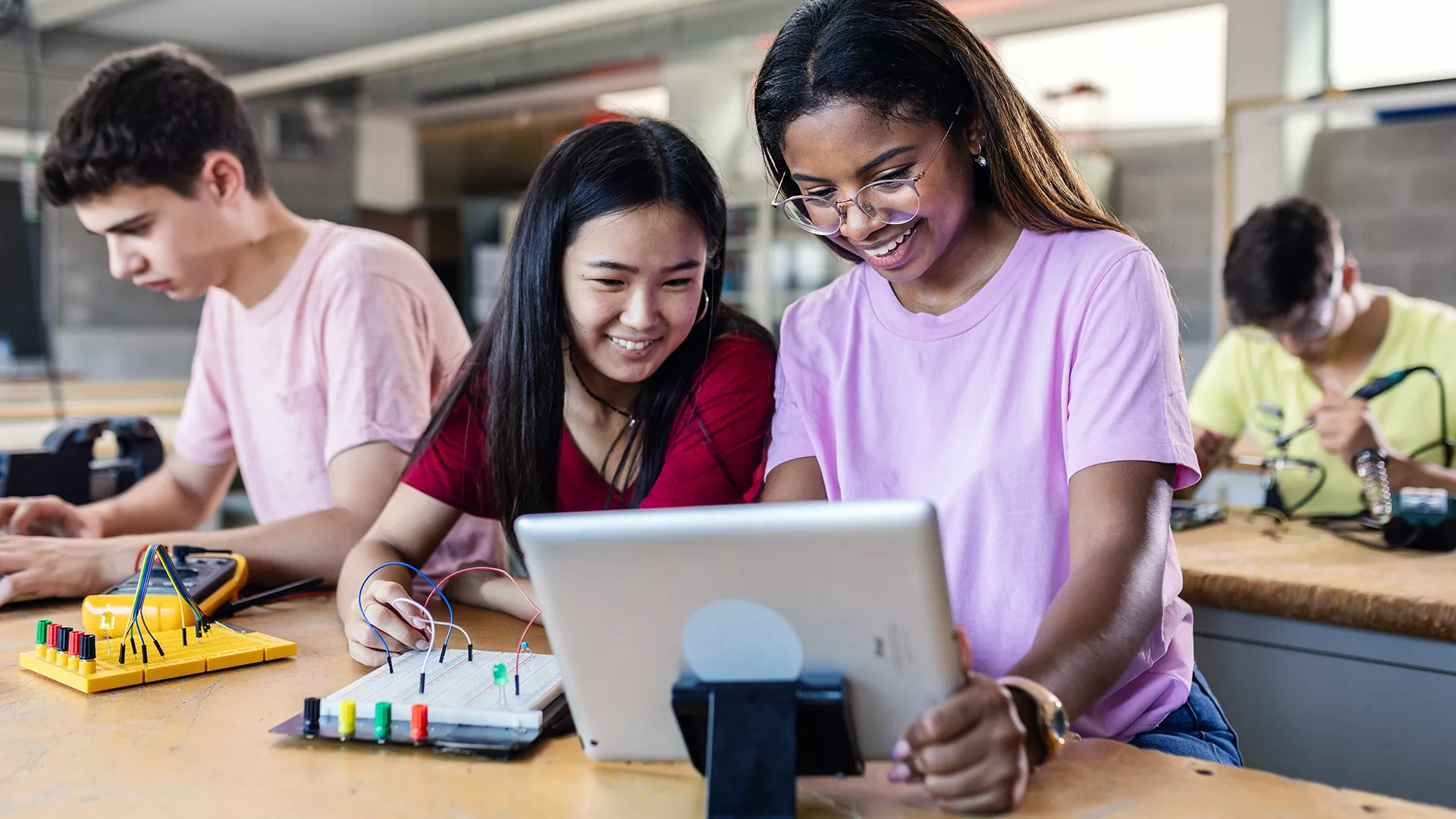 Middle school girls working on circuit project in science class