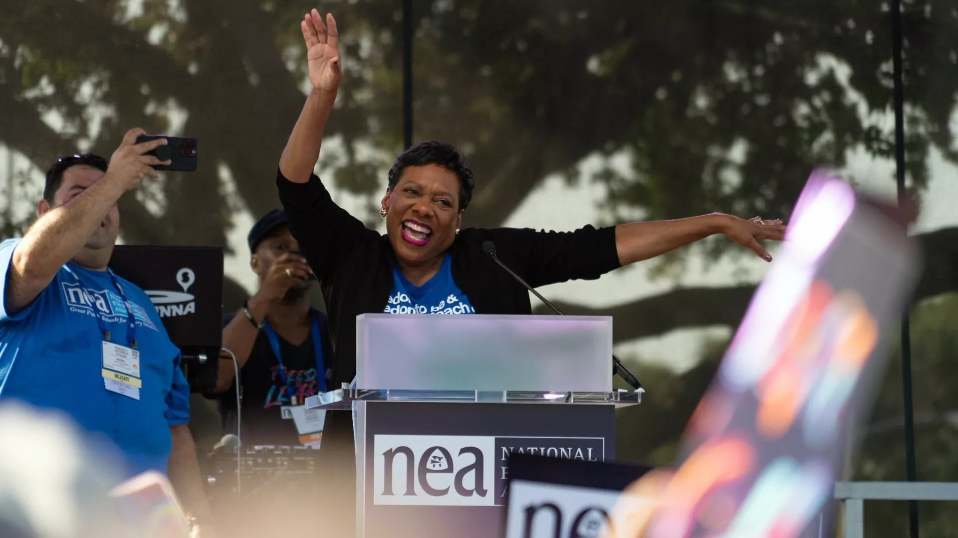 NEA President Becky Pringle raises her arms and cheers with the crowd at the July 5 2023 Freedom to Learn rally in Orlando
