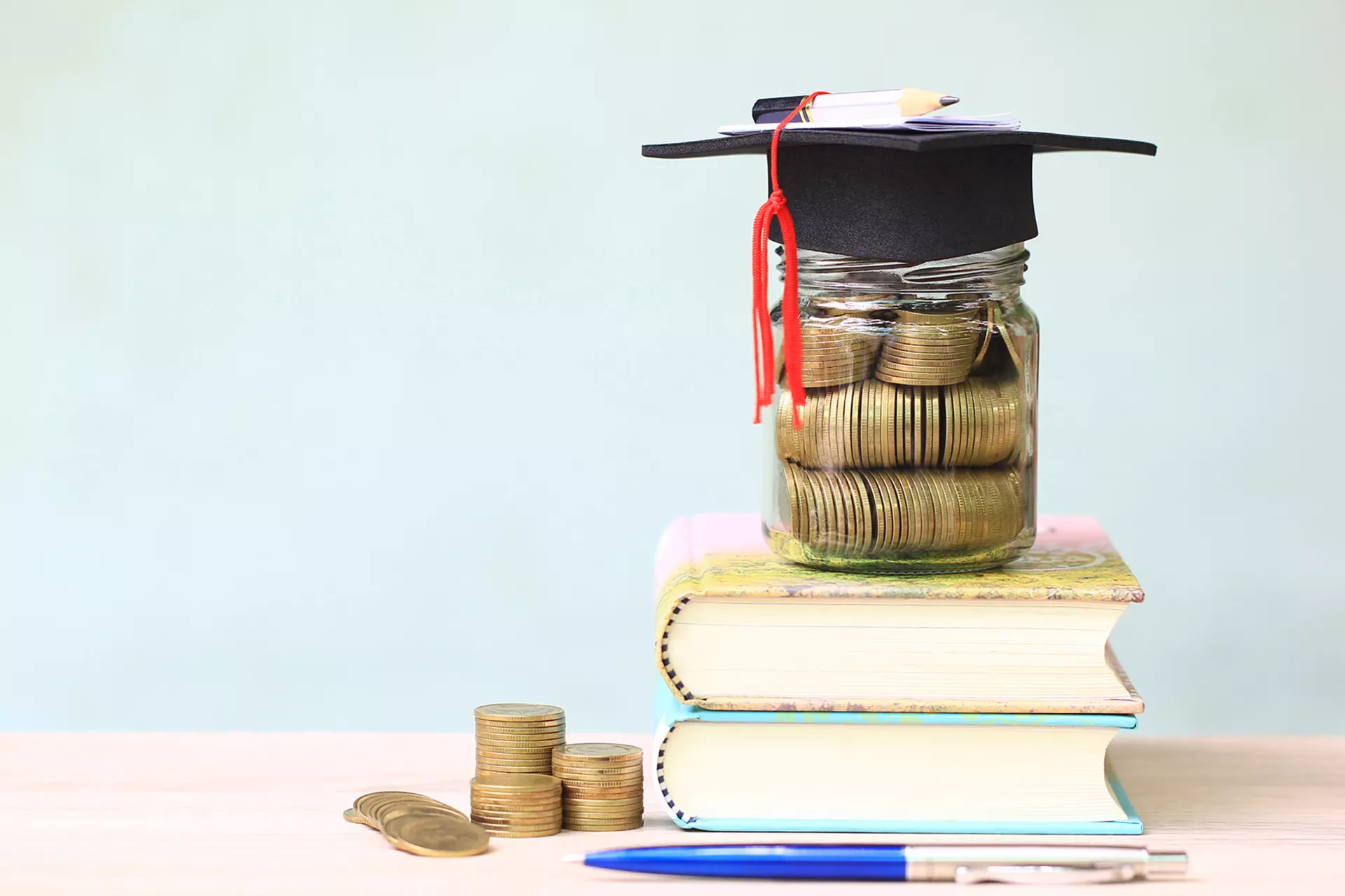 Change jar with graduation cap on top of books.