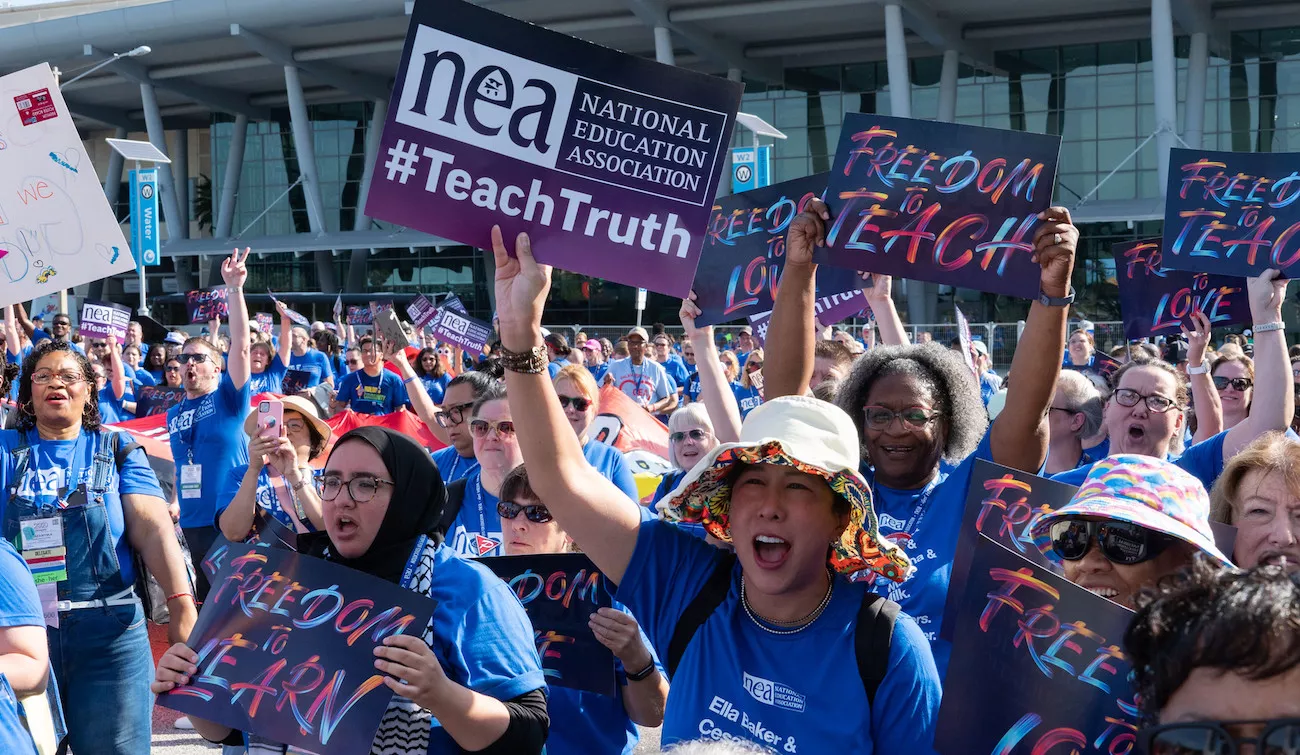 Educators hold Freedom to Teach signs at rally in Orlando