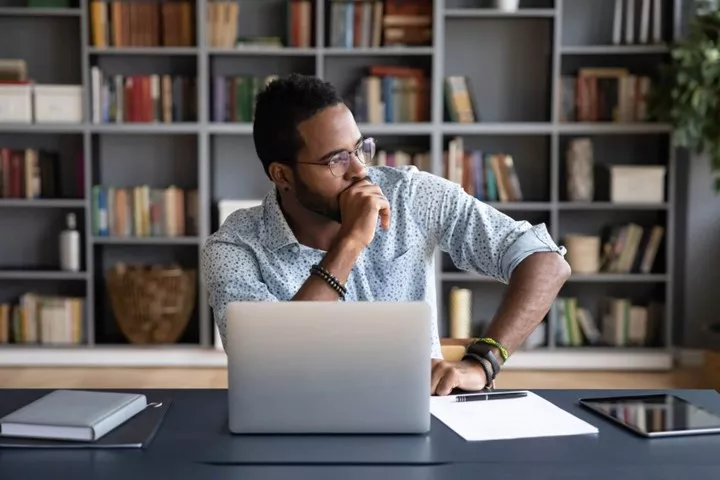 Man at desk looking stressed