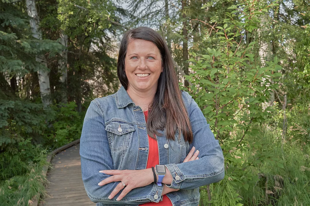 Portrait image of Jennifer Pyle standing on a trail.