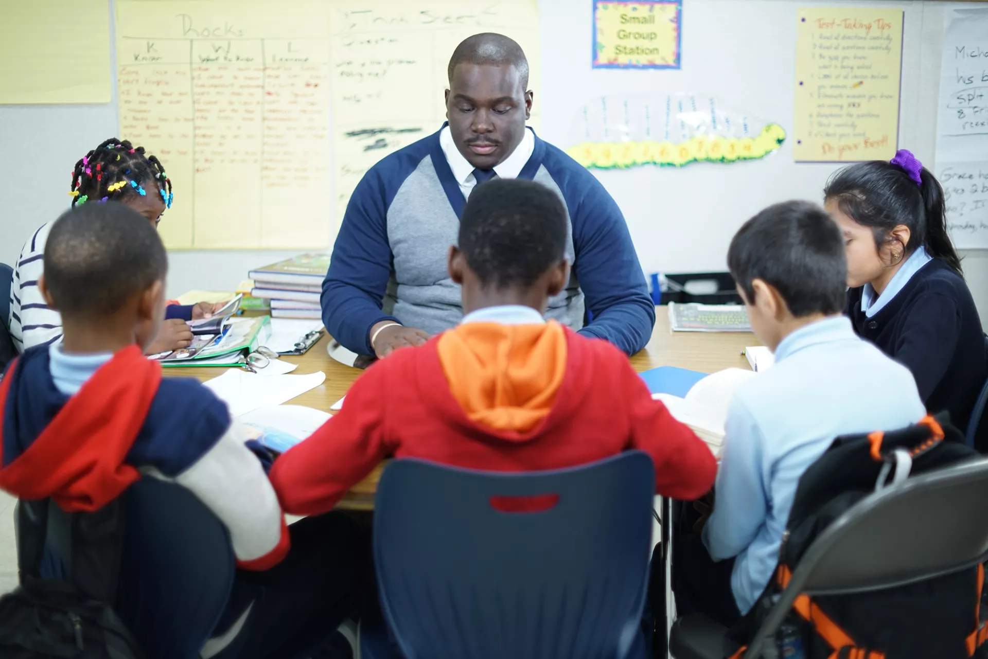 Male educator pictured with students