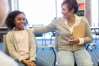 School counselor supports a young student during a group session