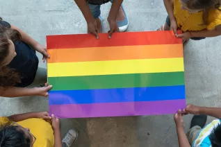 Children hold a Pride flag