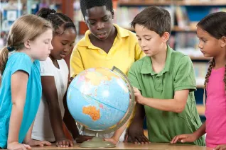 Kids surrounding a globe