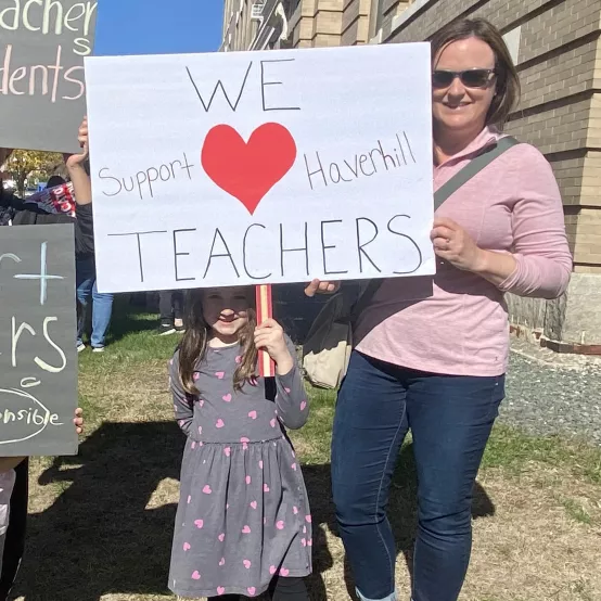 Child with sign saying We Support Haverhill Teachers