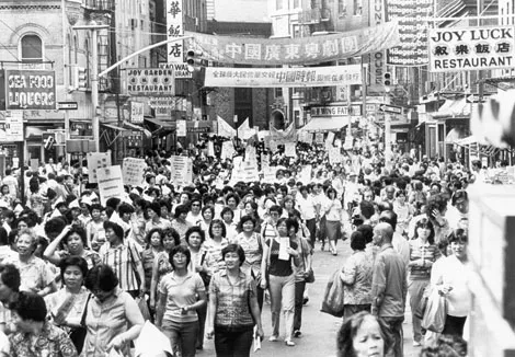 Photo of women marching through Chinatown