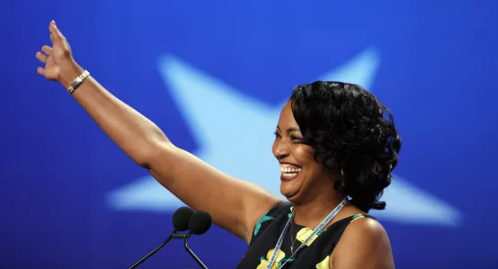 Photo of teacher Jahana Hayes, raising hand at RA