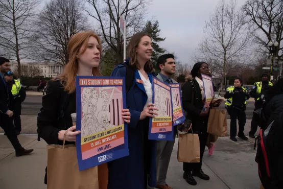 Photo of young people with debt signs at Supreme Court