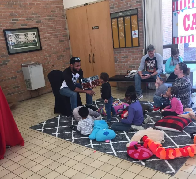 SCORE leaders read to pre-K students.
