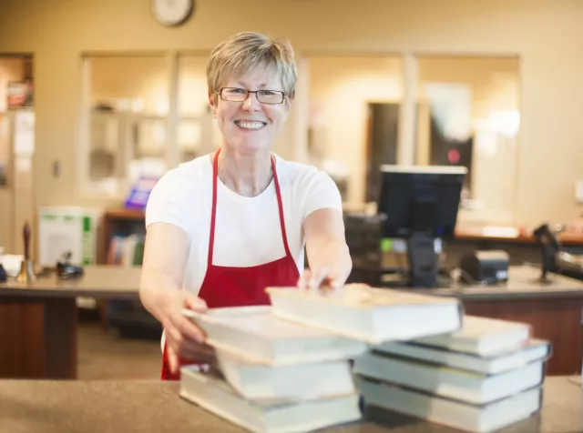A librarian checks out books.