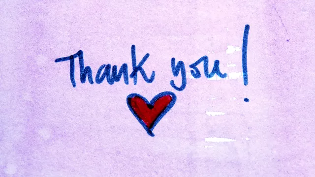 handwritten purple post-it that says Thank you with a heart
