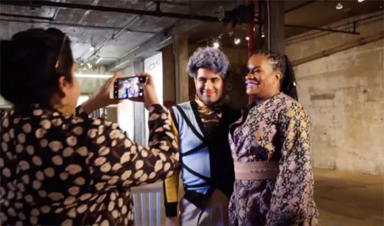 Woman takes a photo of two other women